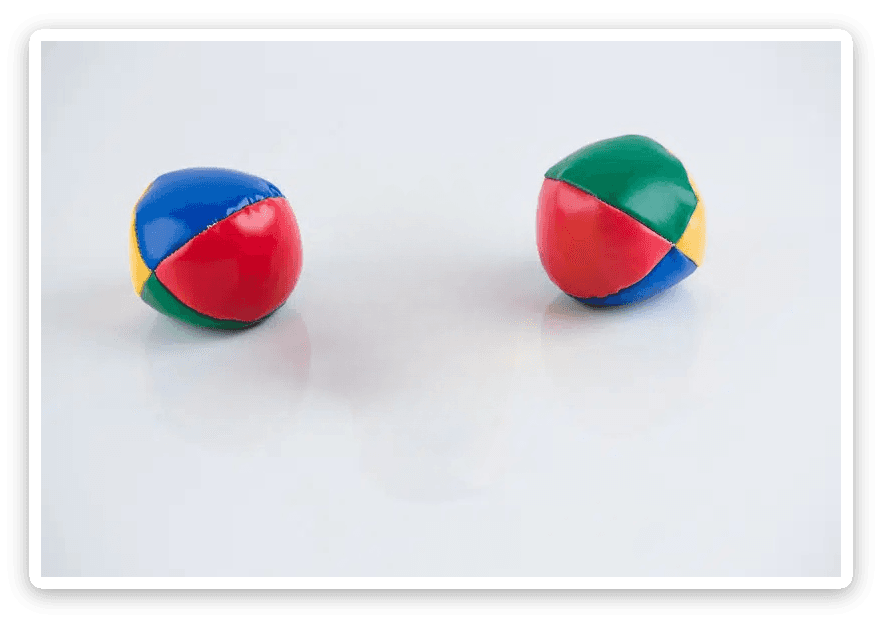 Two juggling balls after middle one was removed — clean background